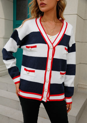 Navy and white striped knit cardigan with pearl buttons and red trim.