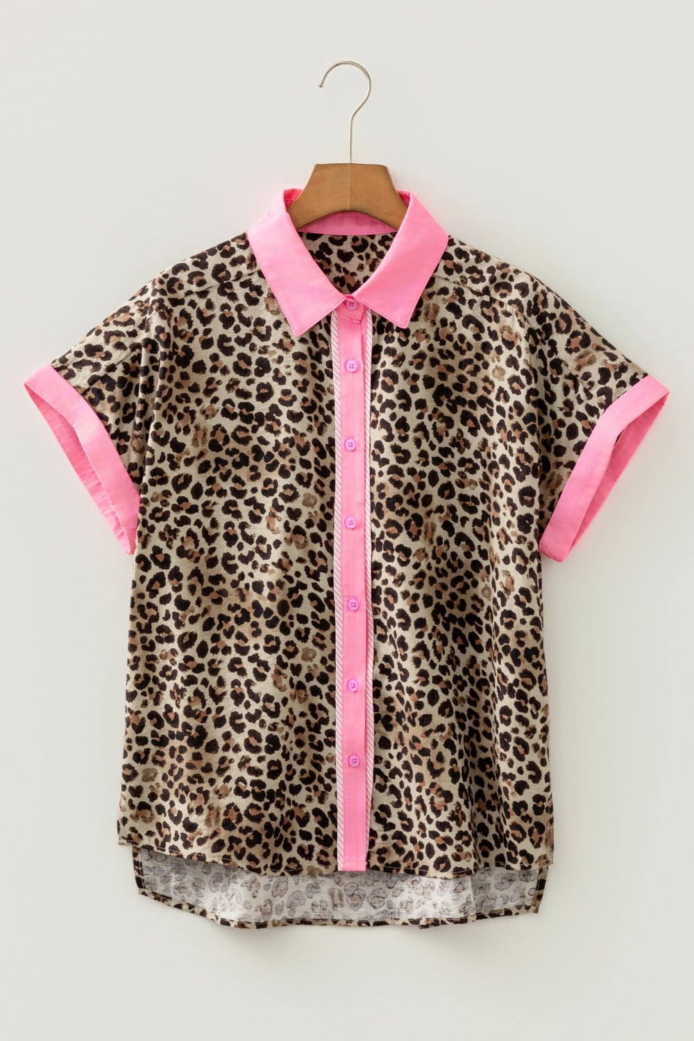 Print short sleeve button up shirt with pink collar, cuffs, and placket.