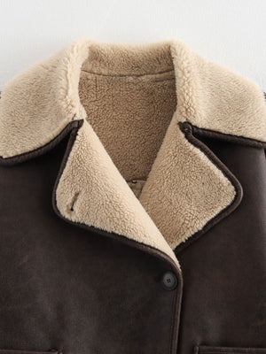 Brown aviator jacket with shearling trim and collar, button closure.
