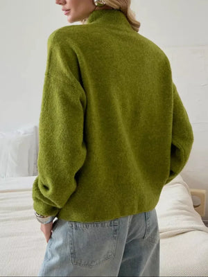Relaxed mock neck knit sweater in moss green acrylic blend with dropped shoulders.