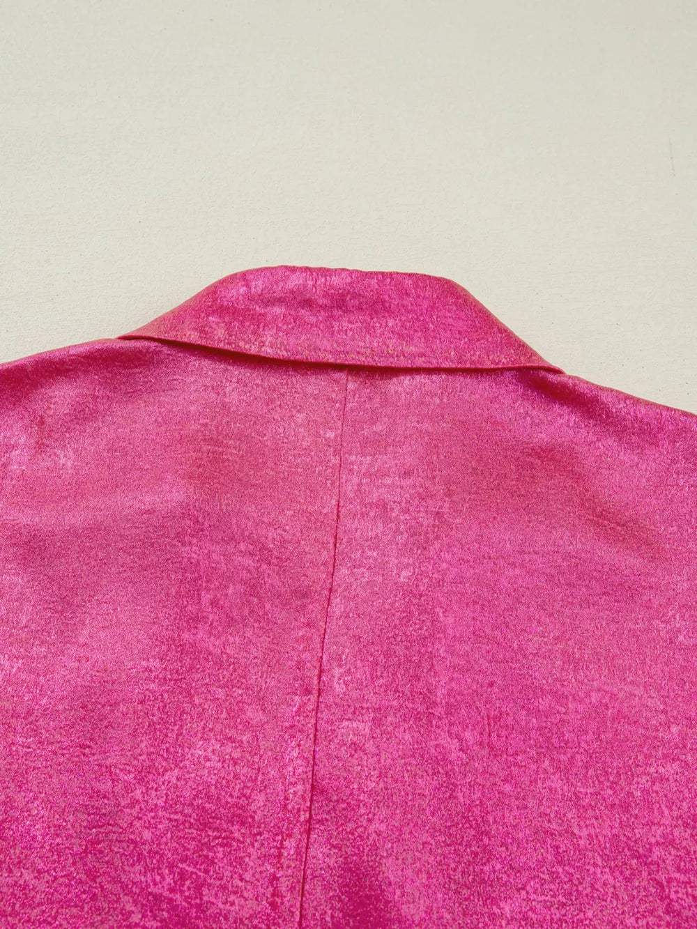 Lustrous collared V-neck maternity shirt in deep rose polyester with a textured finish.