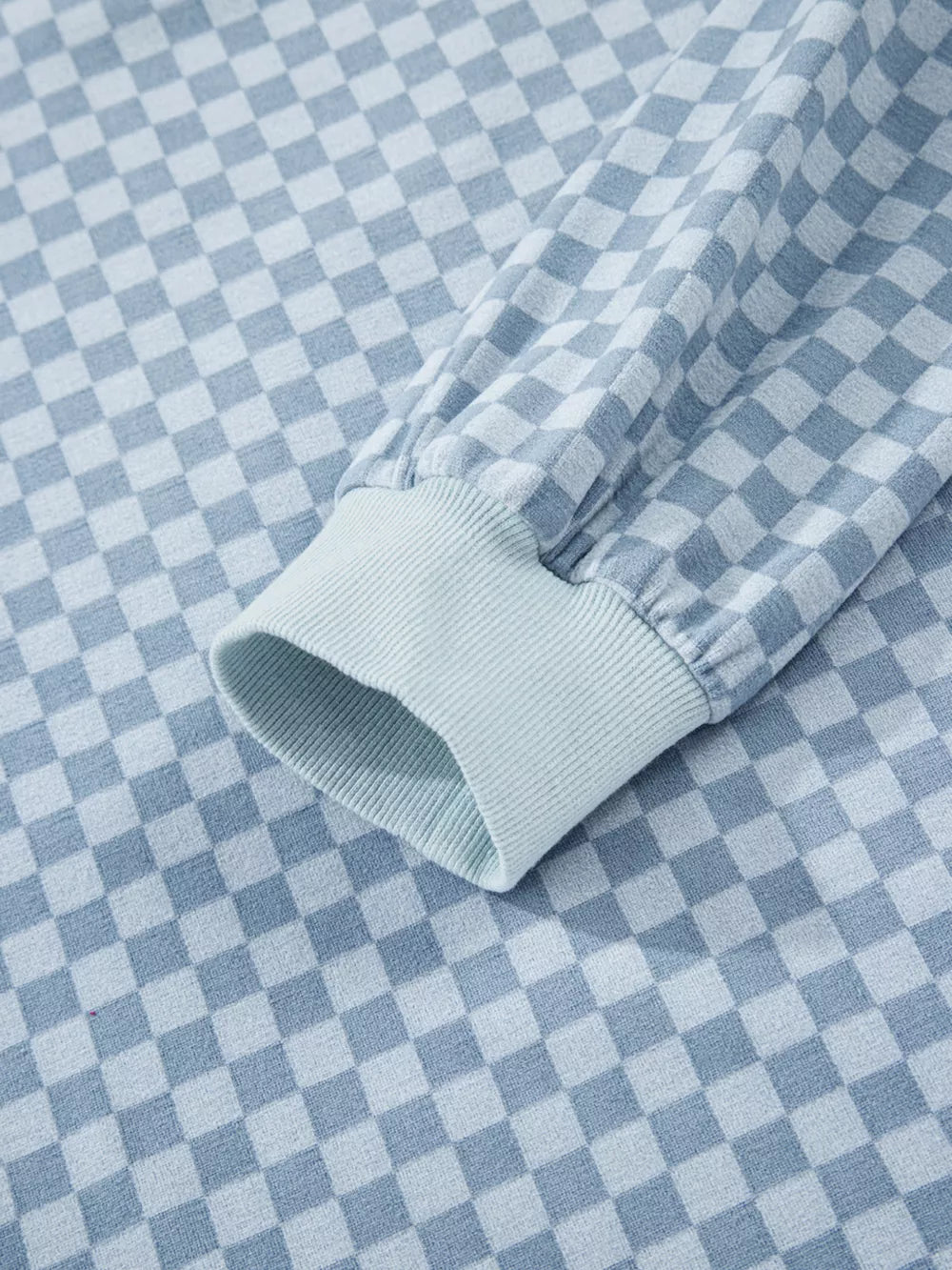 Light blue checkerboard loungewear pullover sleeve detail with ribbed cuff