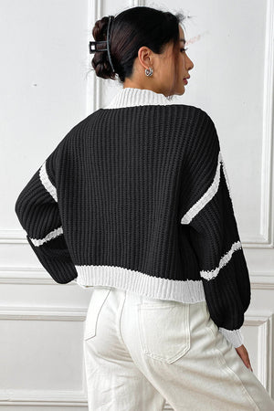 Colorblock ribbed black cardigan with white trim and sleeve details, cropped length
