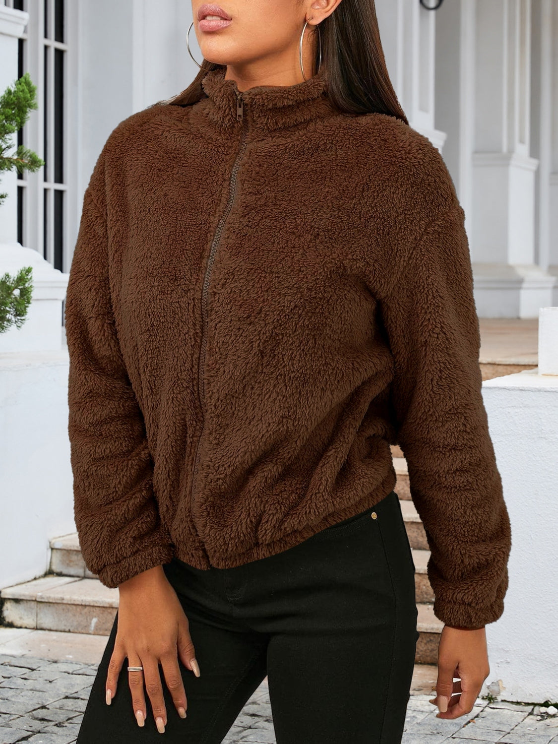Brown sherpa bomber jacket with zip front and stand-up collar.