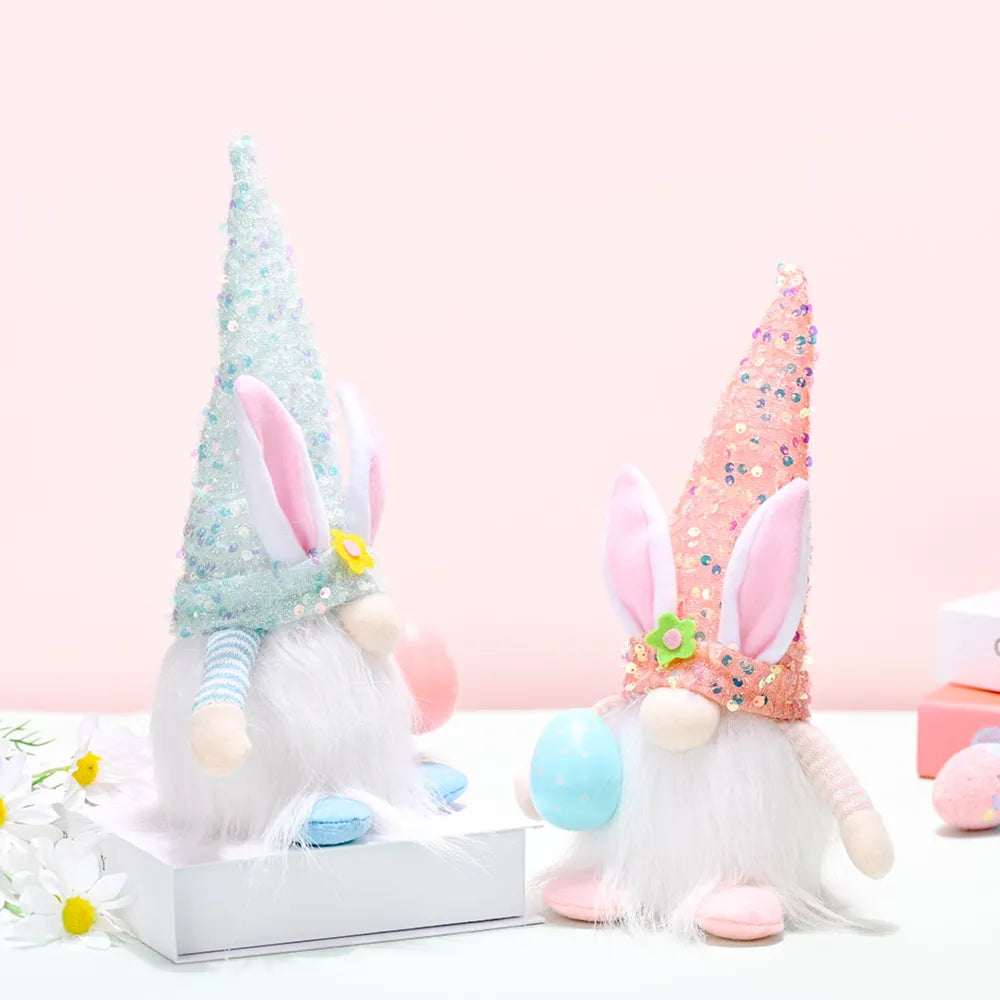 Easter bunny gnomes with sequin cone hats in light blue and coral, holding eggs.