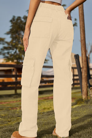 Utility pocket denim trousers in Tan with multiple cargo pockets and elastic waistband.