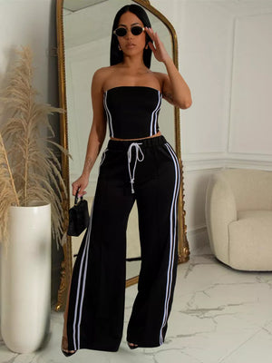Black tube top and wide-leg pants set with white side stripes and drawstring waist.