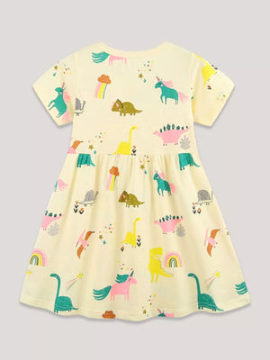 Yellow cotton toddler dress with a whimsical dinosaur and unicorn print.