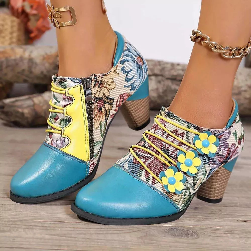 Floral patchwork ankle boots with blue toe, yellow laces, and flower details.
