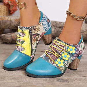 Floral patchwork ankle boots with blue toe, yellow laces, and flower details.