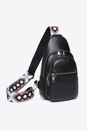 Black crossbody bag with geometric strap and multiple zippered pockets