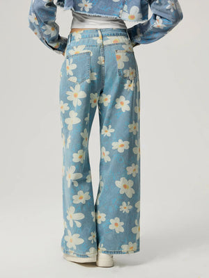 Light wash denim wide leg jeans with a white daisy print and button closure.
