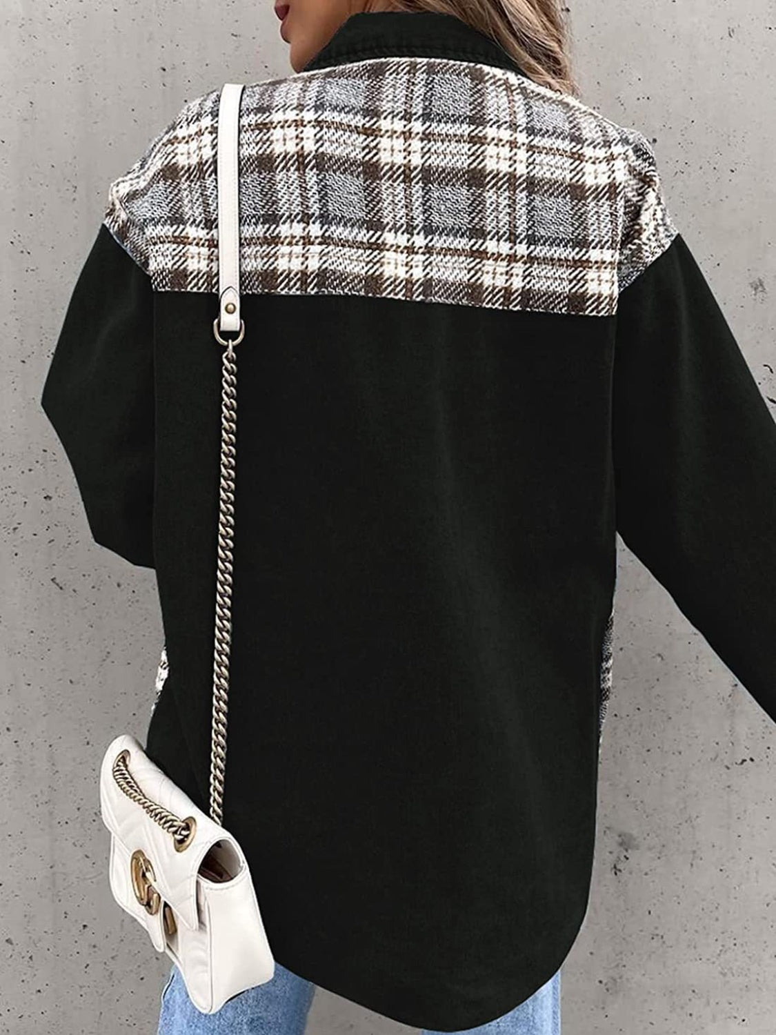 Black denim jacket with plaid paneling on shoulders and upper back.