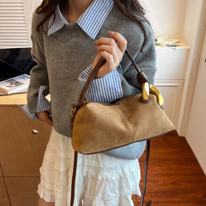 Taupe suede crossbody bag with gold hardware detail