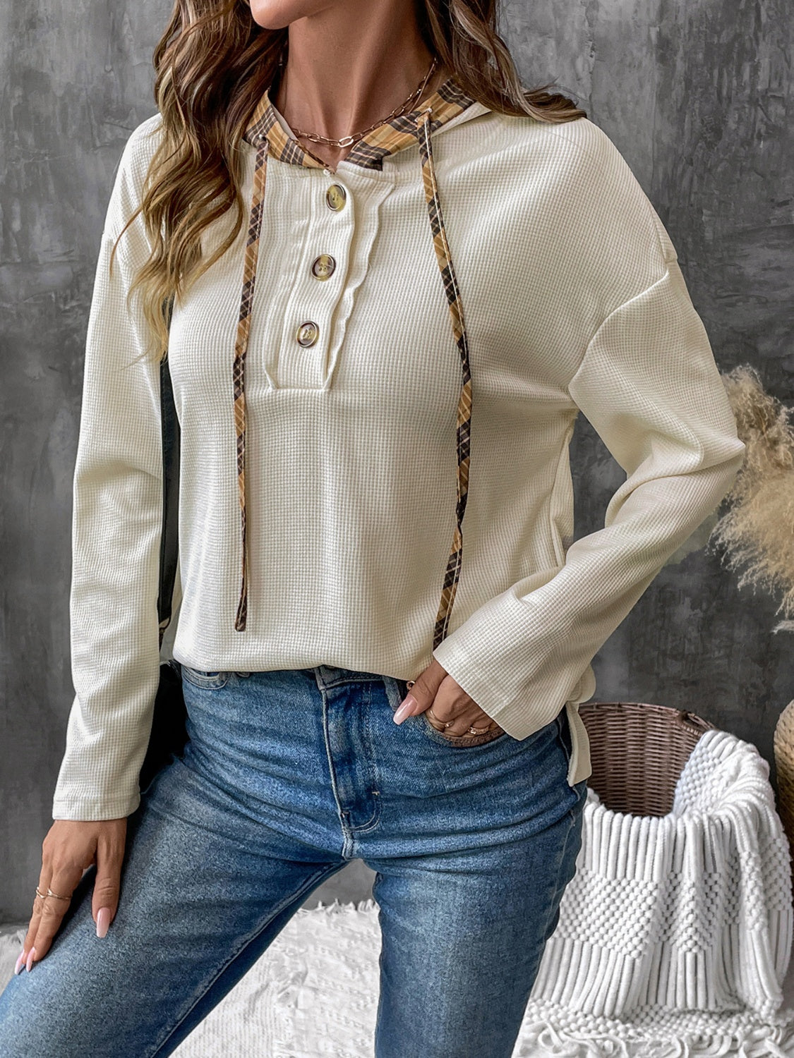 Cream waffle knit henley hoodie with plaid trim and button detail.