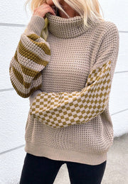 Turtleneck sweater with checkerboard and stripe sleeves in mocha acrylic knit.