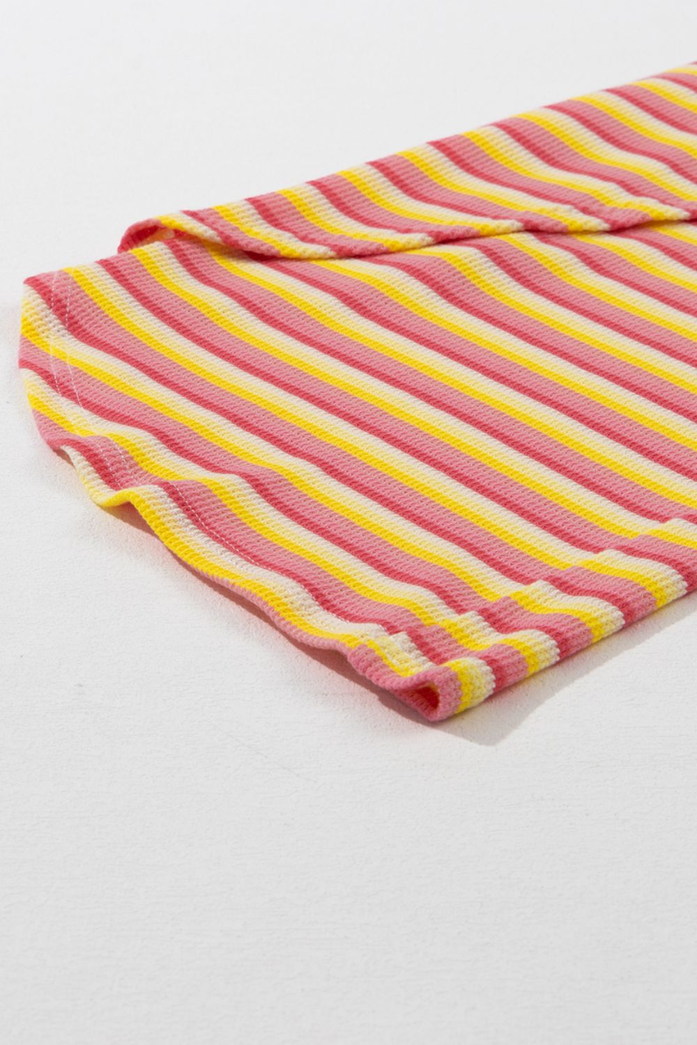 Rainbow stripe culotte jumpsuit in sherbet pink and yellow cotton with drawstring detail.