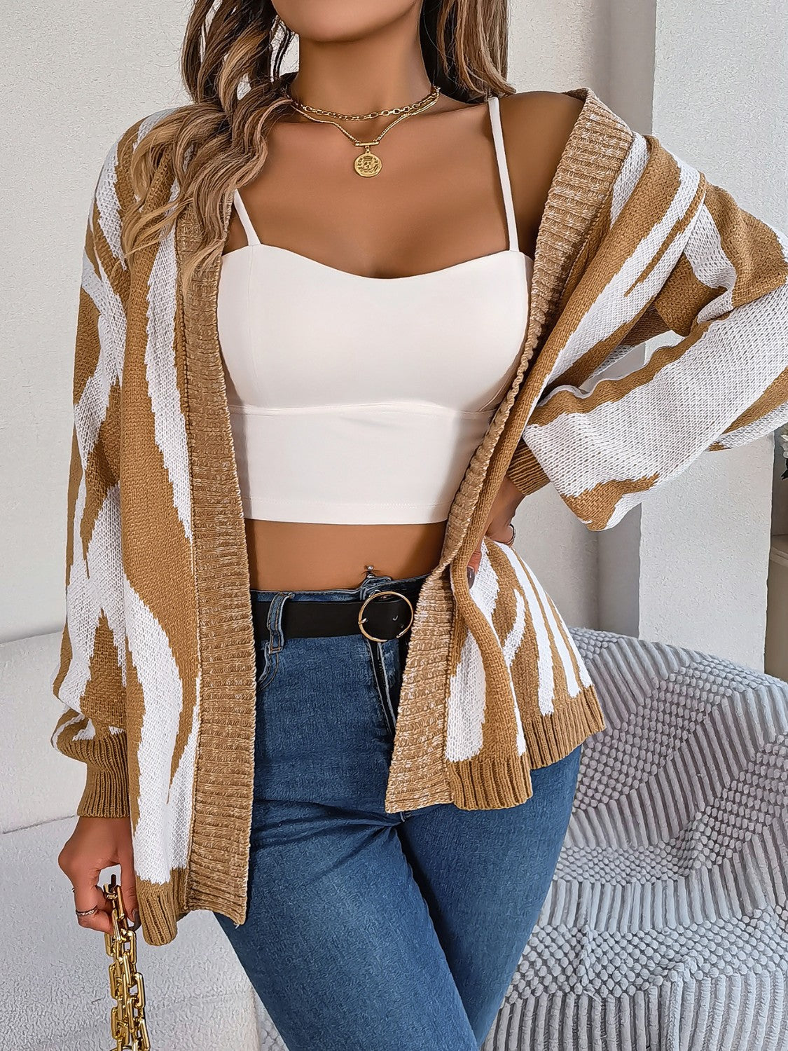 Tan and white zebra stripe open-front knit cardigan with a relaxed fit.