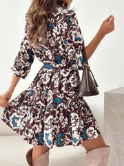 Brown floral tie-waist mini dress with tiered skirt and button details.