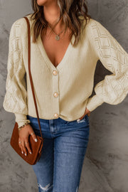 Cream knit cardigan with diamond-cut sleeves and button front