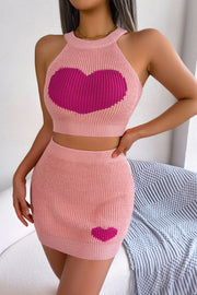 Peach knit halter crop top with pink intarsia heart and matching mini skirt with heart detail.