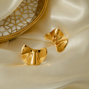 Sculpted gold petal stud earrings with a fluid, organic shape.