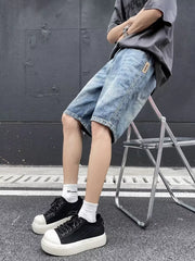 Relaxed fit blue denim shorts with a vintage wash and a small patch detail.