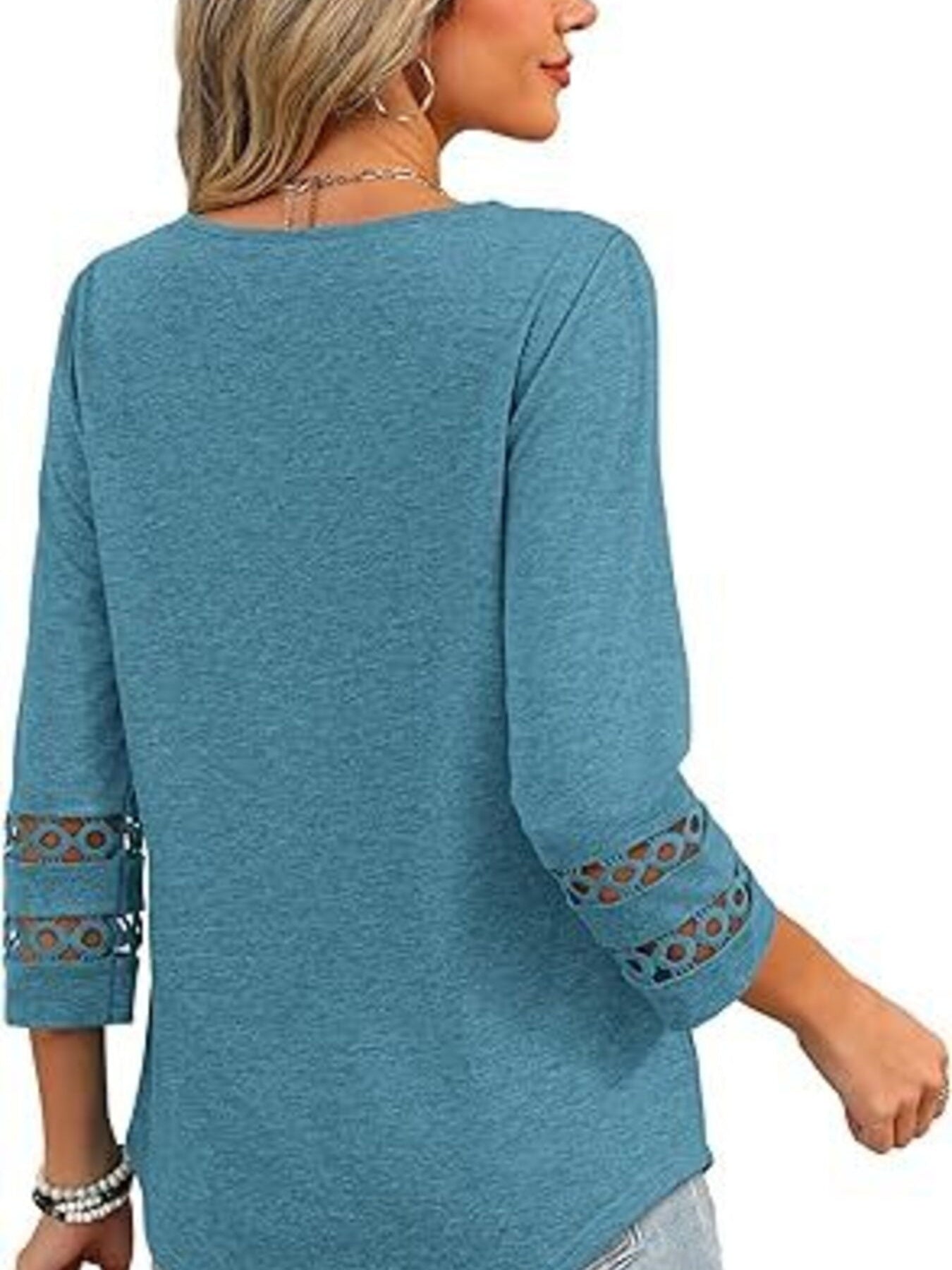 Blue 3/4 sleeve t-shirt with cutout detail on sleeves.