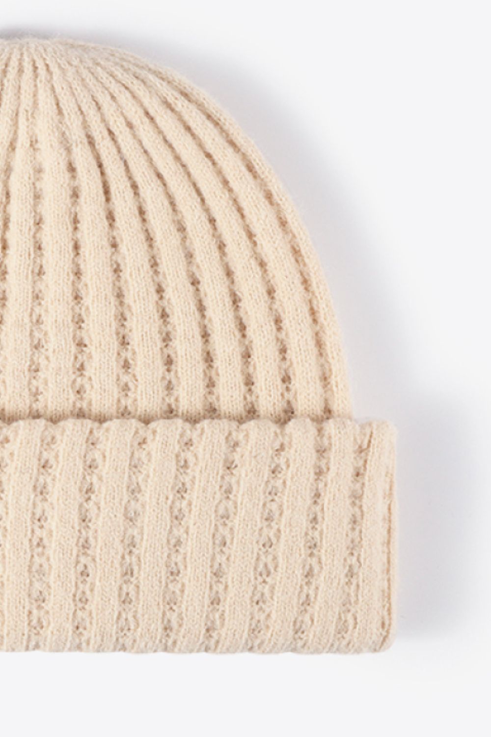 Beige ribbed knit beanie with subtle diamond pattern detail