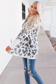 Open-front knit cardigan with blush leopard print and long sleeves.
