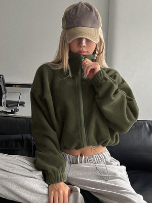 Olive fleece cropped jacket with funnel neck and zipper, styled with sweatpants.