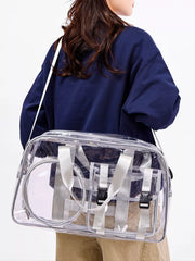 Chic clear PVC travel bag with pink accents and adjustable strap.
