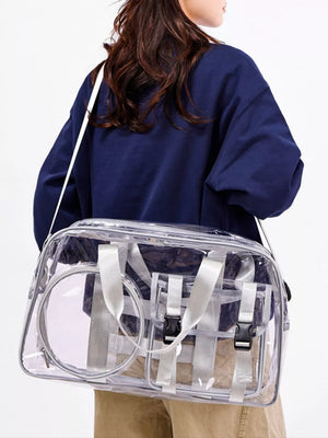 Chic clear PVC travel bag with pink accents and adjustable strap.