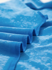Mineral washed blue cotton t-shirt with crew neck and rolled sleeves.