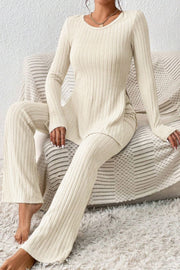 Cream ribbed knit co-ord set with long sleeves, flared pants and side slit top.