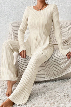 Cream ribbed knit co-ord set with long sleeves, flared pants and side slit top.