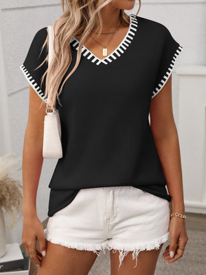 Black knit v-neck top with white contrast trim on neckline and sleeves