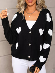 Black button up cardigan with white heart pattern, V-neck, acrylic knit.