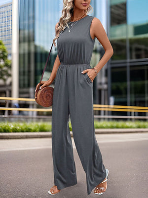Sleeveless dark gray palazzo jumpsuit with gathered waist and pockets.