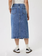 High-slit denim midi skirt in medium wash cotton with back pockets and a raw hem.