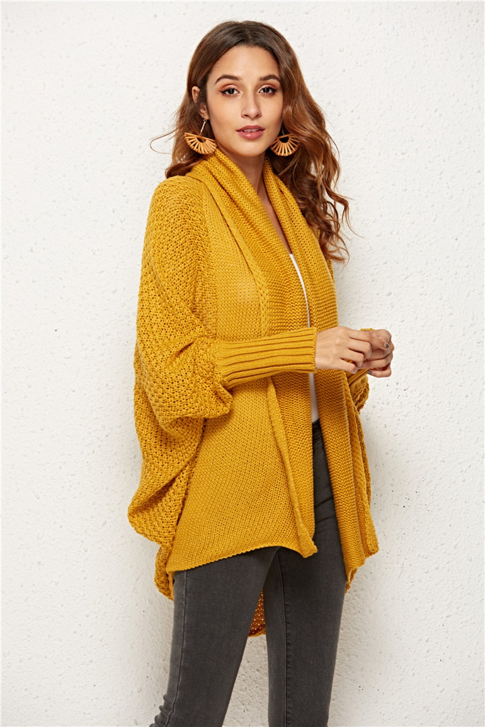 Textured cocoon knit cardigan in gold with batwing sleeves and waterfall neckline.