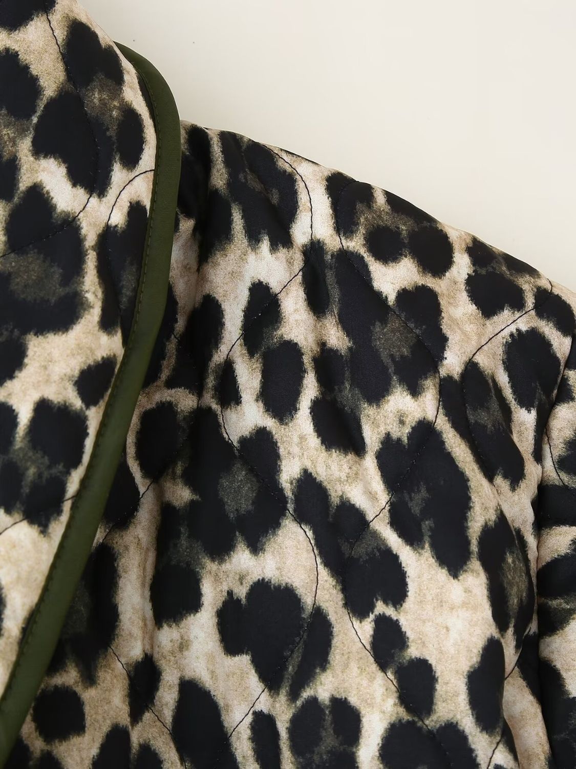 Leopard quilted kimono jacket with green trim and diamond stitching detail.