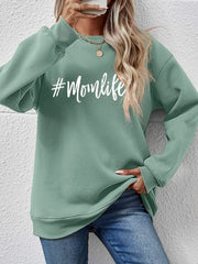 Sage green crewneck sweatshirt with #Momlife graphic, casual relaxed fit.