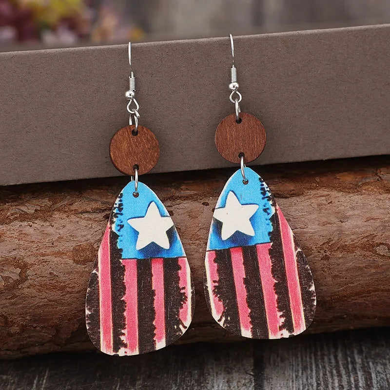 Patriotic wood teardrop earrings with American flag design and white stars.