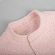 Blush pink textured bouclé bomber jacket with rounded neckline detail