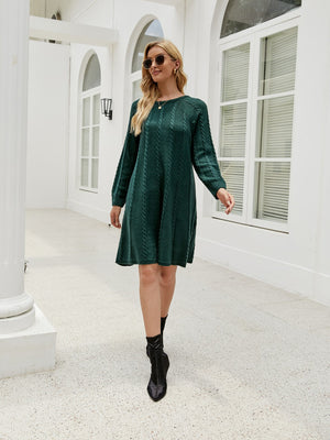 Cable knit A-line sweater dress in Black Forest with crew neck and long sleeves.