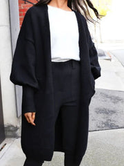 Black acrylic maxi cardigan with balloon sleeves and ribbed cuffs.