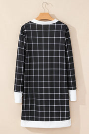 Black and white plaid duster cardigan with white trim and cuffs.