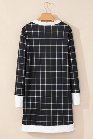 Black and white plaid duster cardigan with white trim and cuffs.
