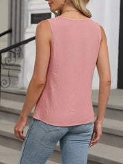 Pink sleeveless tank top with keyhole neck and textured fabric.